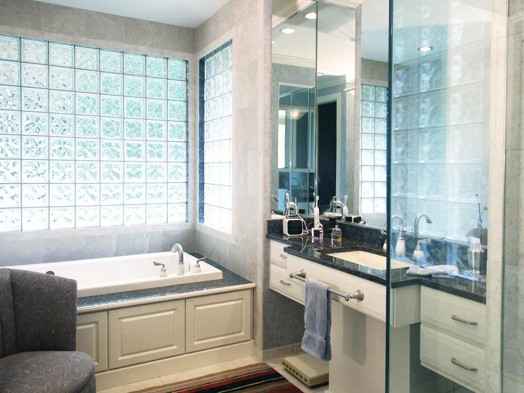 bathroom with thick windows and drop-in tub