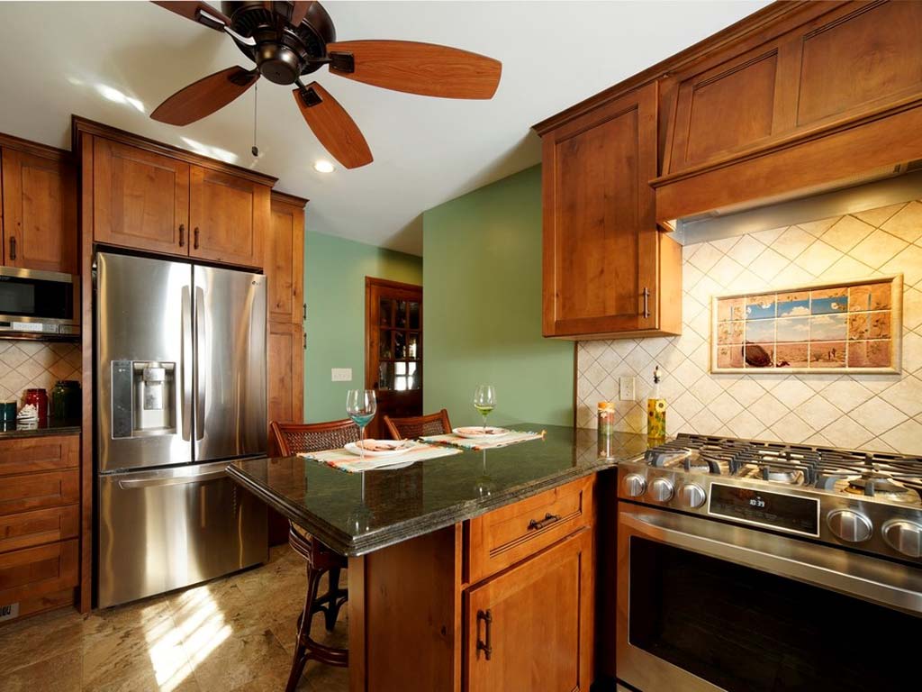 Tropical Green Granite Counters and Knotty Alder Wood Cabinets